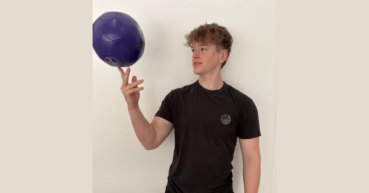 Man with a purple football spinning on his finger
